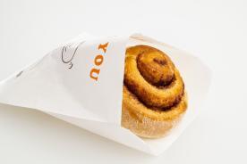 Filled pastry in a greaseproof paper bag
