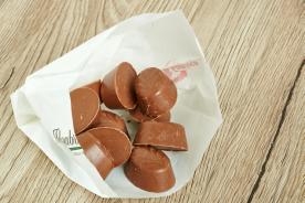 Chocolate candies in a greaseproof paper bag